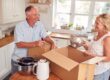 Mature couple packing away boxes