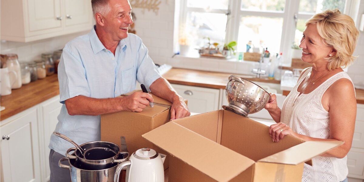 Mature couple packing away boxes