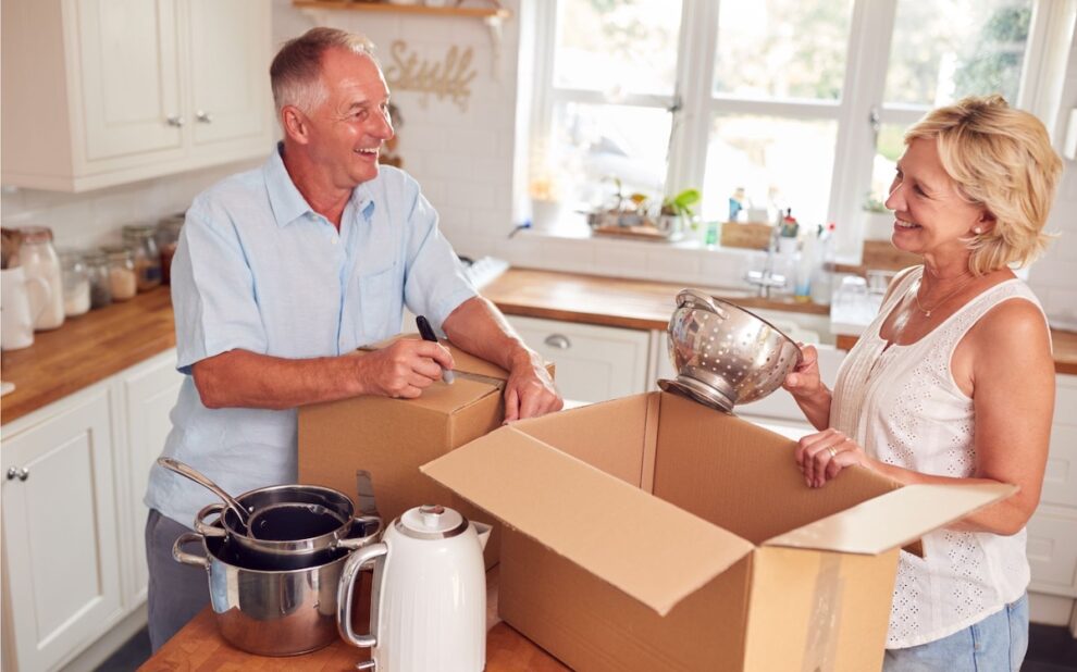 Mature couple packing away boxes