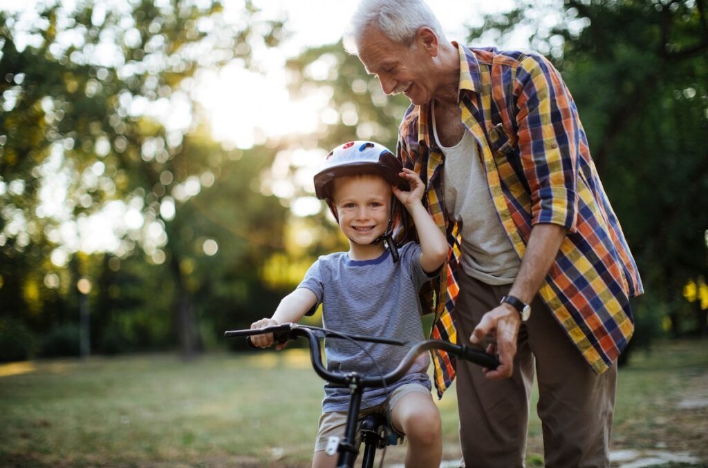Grandfather with grandson riding a bike